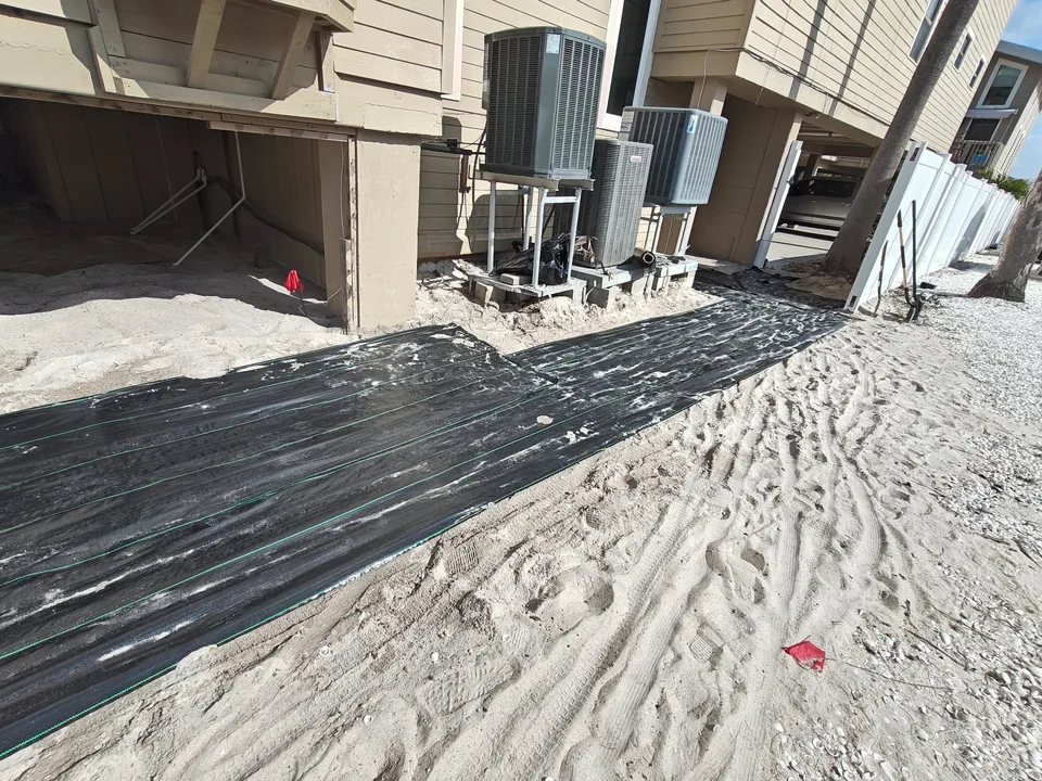 Commercial landscape fabric being installed for coastal shell path Florida